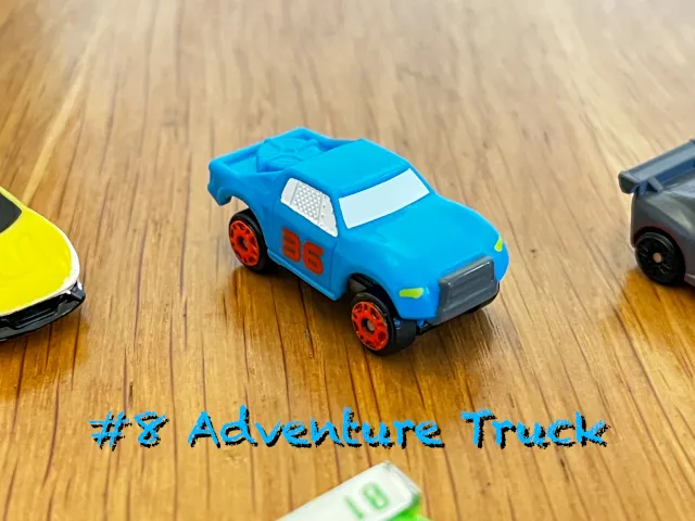 A carousel photo displaying the eighth vehicle named 'Adventure Truck' out of an array of 'Standard cars', at full size. The car/truck is painted turquoise with red wheels and red side-door number '36' printed.