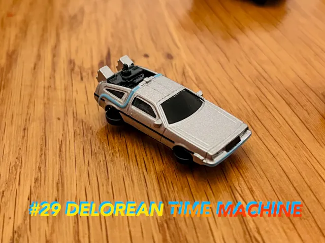 A carousel photo displaying the twenty-ninth vehicle named 'Delorean Time Machine' out of an array of 'Deluxe Cars', at full size. The car is painted sliver incorporating blue pumping veins and is a futuristic time travelling vehicle from the future.