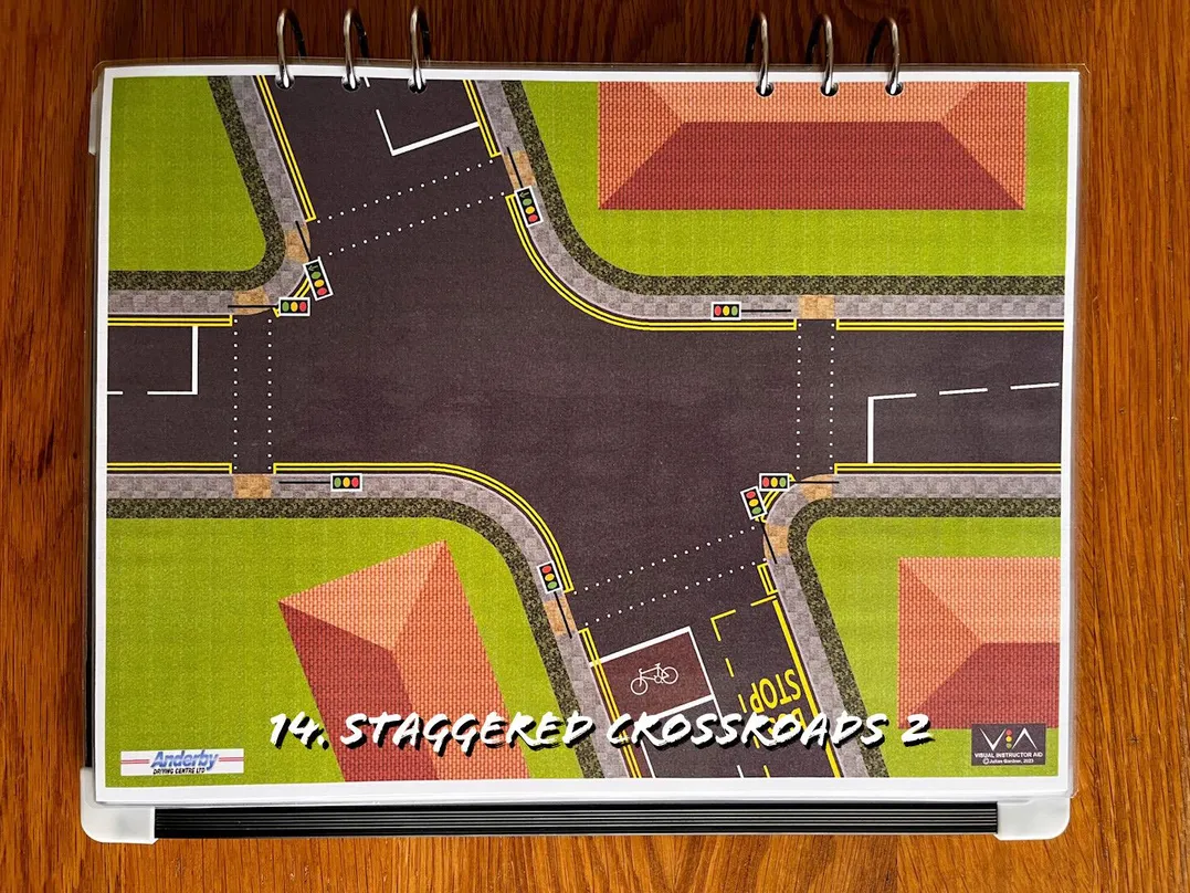 A carousel photo displaying the fourteenth plan named 'staggered crossroads 2' out of an array of roads layouts, at full size. Consisting of a 4-way junction with a clear centre area.