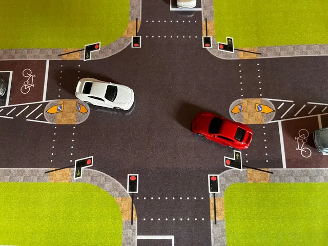 At the traffic light controlled crossroads two miniature vehicles have committed driving towards their desired exits.